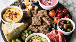Keto-friendly Spring Grazing board with homemade seeded crackers